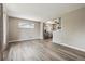 Open-concept living area with new floors and a view of the kitchen at 7833 Raritan St, Denver, CO 80221