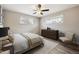Relaxing main bedroom featuring a ceiling fan, wood-look flooring, and large windows with a neutral color scheme at 7833 Raritan St, Denver, CO 80221