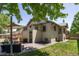 Spacious backyard featuring a patio with outdoor seating, a well-maintained lawn, and mature trees at 3743 N Yates St, Denver, CO 80212