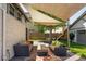 This backyard patio provides a relaxing outdoor space with stylish seating, shade and view to a play area at 3743 N Yates St, Denver, CO 80212