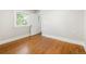 Empty bedroom features hardwood floors, ample natural light through a window, and neutral paint at 3743 N Yates St, Denver, CO 80212