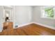 Empty bedroom featuring hardwood floors, ample natural light through a window, and neutral paint at 3743 N Yates St, Denver, CO 80212