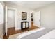 Bright bedroom showing a closet and a doorway to a separate room with hardwood floors and neutral walls at 3743 N Yates St, Denver, CO 80212