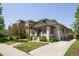 Charming home with a well-manicured lawn, beautiful landscaping, and a welcoming front porch at 3743 N Yates St, Denver, CO 80212