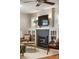 Cozy living room area with a fireplace, built-in shelving, and modern lighting at 3743 N Yates St, Denver, CO 80212