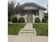 Charming painted brick bungalow with a landscaped front yard, walkway, and inviting front porch at 3743 N Yates St, Denver, CO 80212