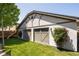 The detached garage compliments the home's architectural details and has a lush, green lawn at 3743 N Yates St, Denver, CO 80212