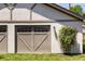 The property features a detached two-car garage with decorative doors and a climbing flower bush on the lawn at 3743 N Yates St, Denver, CO 80212