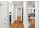 Hallway with hardwood floors offering views into other rooms, including a living area and updated bathroom at 3743 N Yates St, Denver, CO 80212