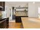 Open kitchen featuring a mosaic backsplash, wine rack, and stainless steel appliances at 3743 N Yates St, Denver, CO 80212