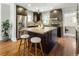 Modern kitchen with stainless steel appliances, a center island, and barstool seating at 3743 N Yates St, Denver, CO 80212