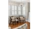 Comfortable seating area with modern chairs, hardwood floors, and abundant natural light through shuttered windows at 3743 N Yates St, Denver, CO 80212