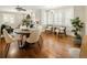 Bright living and dining area featuring hardwood floors and many windows with plantation shutters and stylish decor at 3743 N Yates St, Denver, CO 80212