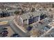 Aerial view of the complex showing parking, landscaping, and multi-story building at 6380 Oak St # 107, Arvada, CO 80004