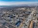 Wide aerial view of the town, showing homes, trees, and roadways nearby at 6380 Oak St # 107, Arvada, CO 80004