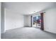 Spacious bedroom featuring sliding glass doors and plush carpeting at 6380 Oak St # 107, Arvada, CO 80004