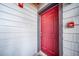 Welcoming red front door with unit number 107 on a well-maintained condo unit at 6380 Oak St # 107, Arvada, CO 80004