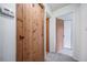 Hallway featuring rustic, solid-wood doors and neutral wall color at 6380 Oak St # 107, Arvada, CO 80004