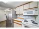 Kitchen featuring white appliances and stainless steel refrigerator at 6380 Oak St # 107, Arvada, CO 80004