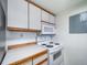 Kitchen featuring white appliances and wooden trim at 6380 Oak St # 107, Arvada, CO 80004