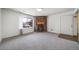 Inviting living room with a stone fireplace, large window, and neutral carpet throughout at 6380 Oak St # 107, Arvada, CO 80004
