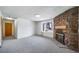 Bright living room features a stone fireplace and large window at 6380 Oak St # 107, Arvada, CO 80004