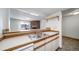 View of the kitchen overlooking a living room with stone fireplace at 6380 Oak St # 107, Arvada, CO 80004
