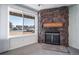Comfortable living room highlighting a stone fireplace with a large window offering natural light at 6380 Oak St # 107, Arvada, CO 80004