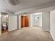 Large basement area with a toilet room, multiple doors, carpet, and ample space for customization at 10862 Albion Dr, Thornton, CO 80233