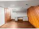 Spacious basement area with wood-look flooring, closet space, and built-in desk and cabinet perfect for home office at 10862 Albion Dr, Thornton, CO 80233