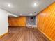 Finished basement with wood-paneled walls, brick accents, and durable flooring, ready for customization at 10862 Albion Dr, Thornton, CO 80233