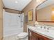 Cozy bathroom featuring a tub with shower, vanity with white countertop and stylish framed artwork at 10862 Albion Dr, Thornton, CO 80233