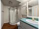 Bathroom with a glass-enclosed shower, vanity, storage cabinet, and modern fixtures at 10862 Albion Dr, Thornton, CO 80233