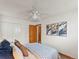 Bright bedroom with a ceiling fan, closet and wood door, decorated with modern framed artwork at 10862 Albion Dr, Thornton, CO 80233