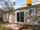 Back exterior showcasing sliding glass doors, a small patio, an additional entrance door, and access to the backyard at 10862 Albion Dr, Thornton, CO 80233