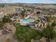 Aerial view of community amenities featuring pools, clubhouse, and scenic landscaping at 10553 Fairhurst Way, Highlands Ranch, CO 80126