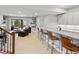 Finished basement with a bar, seating, and a walkout to an outdoor patio at 10553 Fairhurst Way, Highlands Ranch, CO 80126