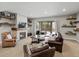 Finished basement living room with a fireplace, shelving, and sliding glass door access to an outdoor patio at 10553 Fairhurst Way, Highlands Ranch, CO 80126