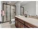 Modern bathroom with a glass-enclosed shower, dark vanity and neutral wall tiling at 10553 Fairhurst Way, Highlands Ranch, CO 80126