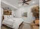 Cozy bedroom features a floral comforter, ceiling fan and decorative tapestry above the bed at 10553 Fairhurst Way, Highlands Ranch, CO 80126