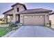 Charming home with a stone facade, landscaped front yard, and a two-car garage at 10553 Fairhurst Way, Highlands Ranch, CO 80126
