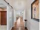 Inviting hallway with hardwood floors and stylish decor leading to living spaces at 10553 Fairhurst Way, Highlands Ranch, CO 80126