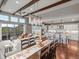 Open-concept living area featuring hardwood floors, exposed beams, and a modern kitchen with an island at 10553 Fairhurst Way, Highlands Ranch, CO 80126