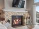 Cozy living room featuring a stone fireplace and a TV at 10553 Fairhurst Way, Highlands Ranch, CO 80126