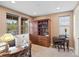 Cozy office space featuring built-in shelving, a large desk, and natural light at 10553 Fairhurst Way, Highlands Ranch, CO 80126