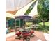 Relax in this beautiful backyard featuring a patio with seating, a shade sail, and a well-maintained garden shed at 12175 Birch St, Thornton, CO 80241