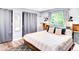 Comfortable bedroom with modern decor featuring a large bed, stylish lighting, and bright window at 12175 Birch St, Thornton, CO 80241