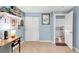 This bedroom features neutral carpet, built-in shelves, and ample closet space for practical storage solutions at 12175 Birch St, Thornton, CO 80241