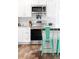 Modern kitchen with stainless steel appliances, granite countertops, and stylish breakfast bar seating at 12175 Birch St, Thornton, CO 80241