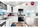 Bright kitchen featuring stainless steel appliances, granite countertops, and a sliding glass door at 12175 Birch St, Thornton, CO 80241
